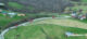 Aerial view of red brine haulers traveling on rural roads near homes in Moundsville, West Virginia.